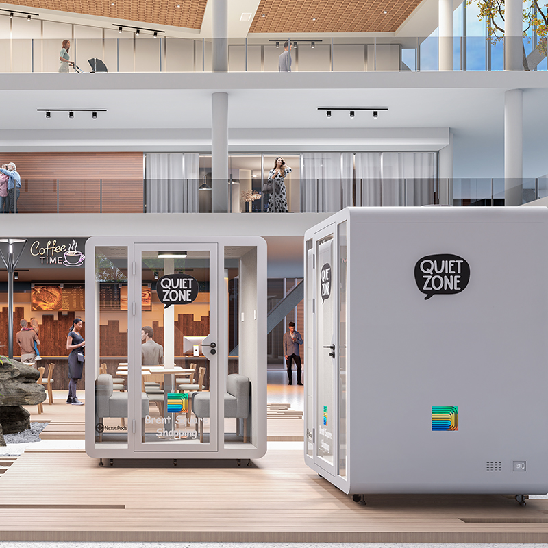 Two 6-person hex soundproof booths near each other in a shopping centre walkway, marked as 'quiet zone' with the shopping centre's logo and name displayed.