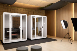 Two Quad Booths side by side in a recording studio, providing soundproof spaces for music production and collaboration.